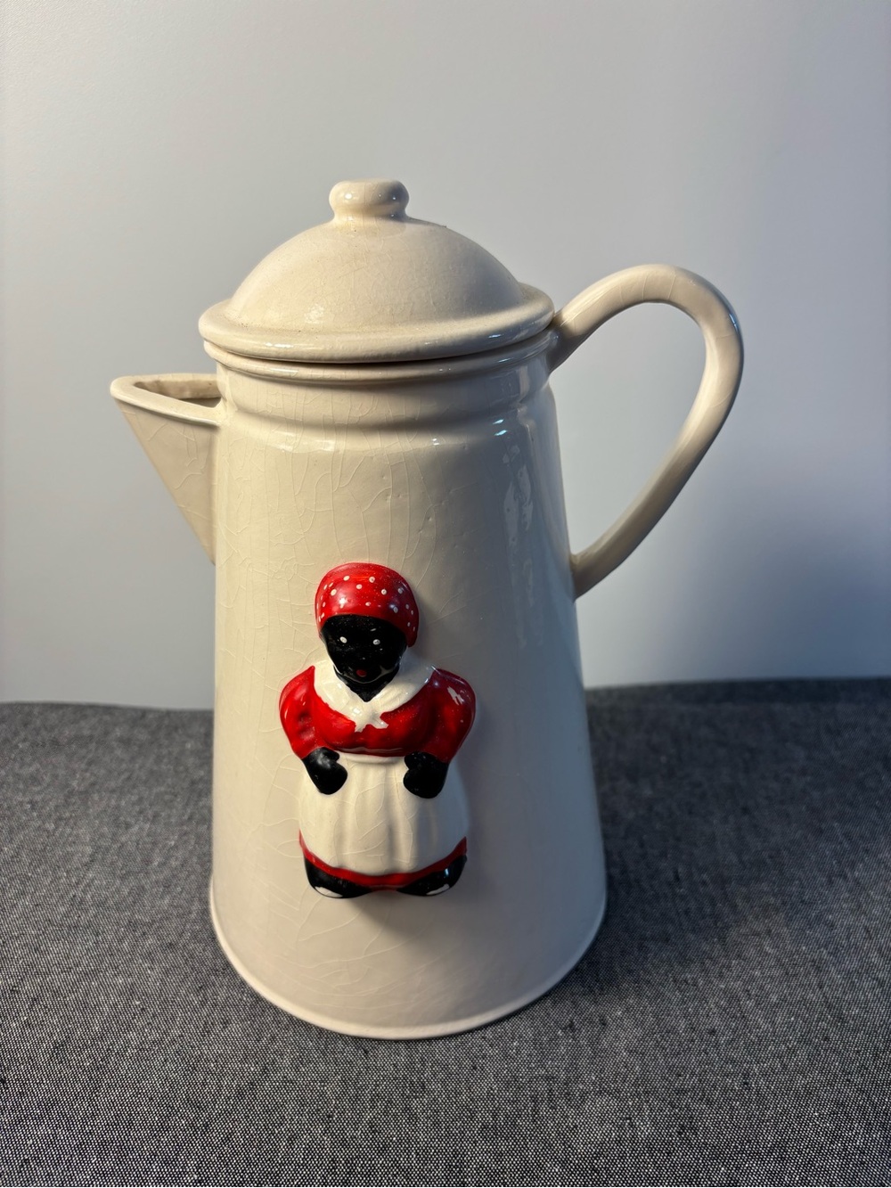 Antique and very rare. Cream Ceramic Coffee Pot with Lady in Red Figurine